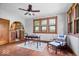 Bright living room with hardwood floors, wooden window frames, and a cozy seating area at 1497 Clinton St, Noblesville, IN 46060