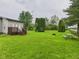 Backyard with a patio, fire pit, picnic table, and ample greenspace at 1520 E Kirk St, Muncie, IN 47303