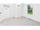 Bedroom with neutral carpet, white walls, closet, and large window at 1520 E Kirk St, Muncie, IN 47303