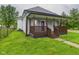 Charming covered front porch with wood railing and steps, adding curb appeal to the home's exterior at 1520 E Kirk St, Muncie, IN 47303