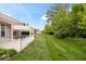 A beautiful backyard featuring a patio and manicured lawn extending to the property line at 16573 Cava Dr, Fishers, IN 46037