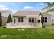 Backyard features a pergola over a patio with white railing and green lawn at 16573 Cava Dr, Fishers, IN 46037