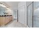 Bathroom featuring double sinks, a glass-enclosed shower, and ample counter space at 16573 Cava Dr, Fishers, IN 46037