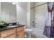 Clean bathroom with a vanity sink with dark countertop and shower/tub combination at 16573 Cava Dr, Fishers, IN 46037
