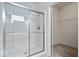Modern bathroom featuring a glass-enclosed shower and a view of the walk-in closet at 16573 Cava Dr, Fishers, IN 46037