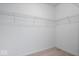 A simple, functional walk-in closet with neutral carpet and metal shelving at 16573 Cava Dr, Fishers, IN 46037