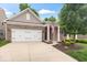 Beautiful brick home showcasing a well-kept lawn, a two-car garage, and a welcoming front entrance at 16573 Cava Dr, Fishers, IN 46037