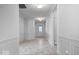 Bright hallway with tiled flooring, elegant wall trim, and a view of the front door with glass panels at 16573 Cava Dr, Fishers, IN 46037