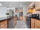 This kitchen features stainless steel appliances, granite countertops, and tile flooring at 16573 Cava Dr, Fishers, IN 46037