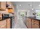 Contemporary kitchen featuring a gas cooktop, wooden cabinets, and an eat-in area with plenty of natural light at 16573 Cava Dr, Fishers, IN 46037