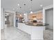 Spacious kitchen with a large island, stainless steel appliances, and views into the hallway and dining area at 16573 Cava Dr, Fishers, IN 46037