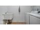 Laundry room features white washer and dryer, utility sink, and white walls at 16573 Cava Dr, Fishers, IN 46037