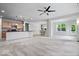 Open-concept living space with kitchen island, carpeted living room, and adjacent dining area at 16573 Cava Dr, Fishers, IN 46037
