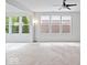 Bright and airy living room with large windows overlooking the backyard at 16573 Cava Dr, Fishers, IN 46037