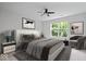 Comfortable main bedroom featuring a ceiling fan, a large bed, and a window with outdoor views at 16573 Cava Dr, Fishers, IN 46037