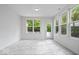 Bright sun room with tiled floor, plenty of windows, and access to the backyard at 16573 Cava Dr, Fishers, IN 46037