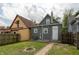 Spacious backyard with a brick firepit and a newly painted gray house at 1661 S Talbott St, Indianapolis, IN 46225