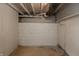 Unfinished basement featuring painted walls, exposed ductwork, and a utilitarian aesthetic at 1661 S Talbott St, Indianapolis, IN 46225