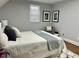 Well-lit bedroom with a stylish chair, decorative wall art, and neutral color scheme at 1661 S Talbott St, Indianapolis, IN 46225