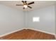 Cozy bedroom featuring hardwood floors, ceiling fan, and a window at 1661 S Talbott St, Indianapolis, IN 46225