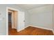 A charming bedroom with hardwood floors and a freshly painted white door at 1661 S Talbott St, Indianapolis, IN 46225