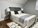 Cozy bedroom featuring a patterned rug, upholstered headboard, and modern decor at 1661 S Talbott St, Indianapolis, IN 46225