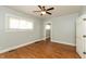 Bright bedroom featuring a ceiling fan, light-colored walls, and hardwood floors at 1661 S Talbott St, Indianapolis, IN 46225