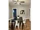 Bright dining room featuring modern black dining table and white chairs at 1661 S Talbott St, Indianapolis, IN 46225