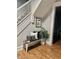 A bench with pillows and a plant next to the staircase creates a welcoming entryway at 1661 S Talbott St, Indianapolis, IN 46225
