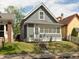 Charming home featuring gray siding, a well-kept lawn, and inviting front steps to the front door at 1661 S Talbott St, Indianapolis, IN 46225