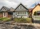 Charming home featuring gray siding, a well-kept lawn, and inviting front steps to the front door at 1661 S Talbott St, Indianapolis, IN 46225