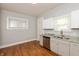 Bright kitchen features stainless steel appliances, gray countertops and hardwood floors at 1661 S Talbott St, Indianapolis, IN 46225