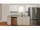 Kitchen with stainless steel appliances, gray countertops, and white cabinets at 1661 S Talbott St, Indianapolis, IN 46225