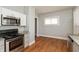 Well-lit kitchen features stainless steel appliances, gray countertops and hardwood floors at 1661 S Talbott St, Indianapolis, IN 46225