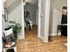A bench with pillows and plant sits near an opening into a dining area with hardwood floors at 1661 S Talbott St, Indianapolis, IN 46225