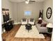 Cozy living room with neutral tones, plush rug, sofa, chairs, and stylish decor at 1661 S Talbott St, Indianapolis, IN 46225