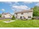 Wide backyard featuring a fire pit, an expansive green lawn, and a charming two-story house at 18915 Fairfield Blvd, Noblesville, IN 46060