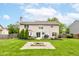 Expansive backyard with lush green grass, a cozy fire pit area, and a well-maintained two-story house at 18915 Fairfield Blvd, Noblesville, IN 46060