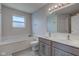 Bright bathroom featuring a double sink vanity, a large mirror, and a relaxing soaking tub at 18915 Fairfield Blvd, Noblesville, IN 46060