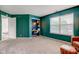 Green bedroom with a desk in closet, and a window letting in natural light at 18915 Fairfield Blvd, Noblesville, IN 46060