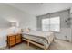Neutral bedroom with carpet, a window letting in natural light, a lamp, and a nightstand at 18915 Fairfield Blvd, Noblesville, IN 46060
