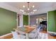 Open dining area with stylish light fixture and views to the living room at 18915 Fairfield Blvd, Noblesville, IN 46060