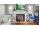 Fireplace with white mantel and hearth with view of front of home on TV above mantel at 18915 Fairfield Blvd, Noblesville, IN 46060