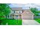 Charming home with brick accents, a two-car garage, well-kept lawn, and a cozy front porch at 18915 Fairfield Blvd, Noblesville, IN 46060