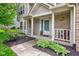 Inviting front porch with decorative hanging plants and manicured landscaping at 18915 Fairfield Blvd, Noblesville, IN 46060