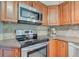 This kitchen features wood cabinets, stainless steel appliances, and stone countertops and backsplash at 18915 Fairfield Blvd, Noblesville, IN 46060