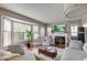 Bright living room with fireplace, large bay windows, hardwood floors, and neutral-toned furniture at 18915 Fairfield Blvd, Noblesville, IN 46060
