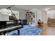 Cozy living room featuring a piano and hardwood flooring at 18915 Fairfield Blvd, Noblesville, IN 46060