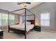 Spacious main bedroom featuring a four-poster bed, windows, and a ceiling fan for enhanced comfort at 18915 Fairfield Blvd, Noblesville, IN 46060