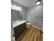 Bathroom features double sink vanity, matching fixtures, and wood-look floors at 1925 W State Road 32, Lebanon, IN 46052